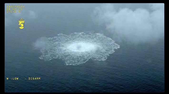 Bubblies froth at the surface of the ocean as clouds hang overhead 