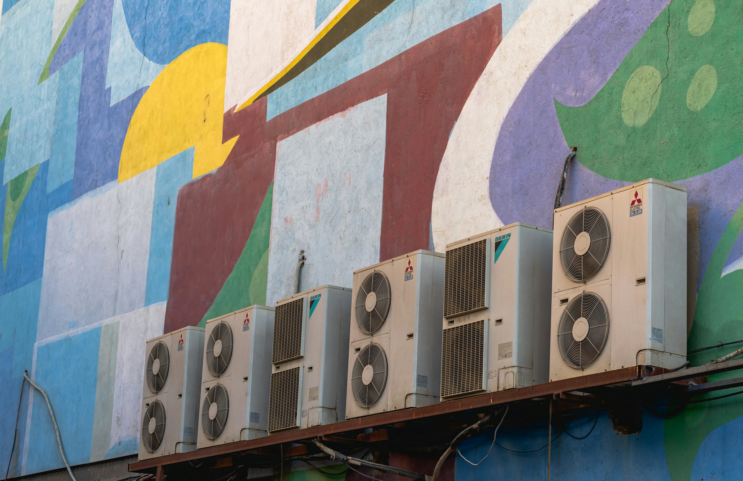 Patterns of the wall of the Bahman cinema and a row of split air conditioners.