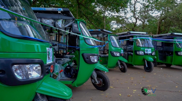 Green electric three-wheelers (e-kekes) lined up side by side at the launch event 